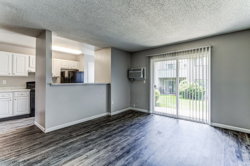 Empty living room and kitchen  at Union Heights Apartments, Colorado Springs, COwith a sliding glass door