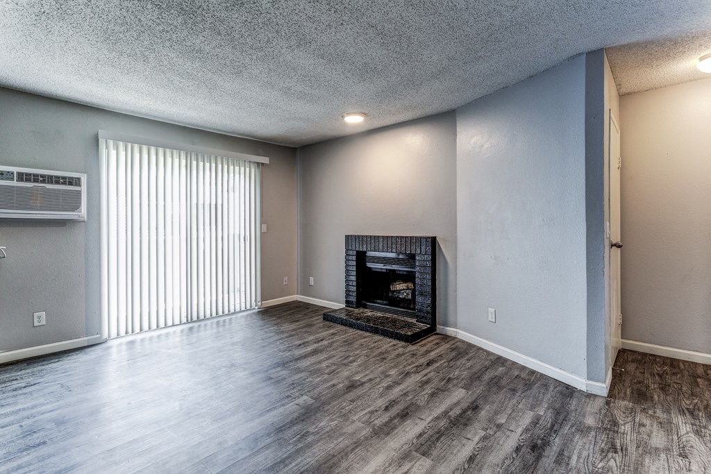 Empty living room with a fireplace and a window  at Union Heights Apartments, Colorado Springs, CO