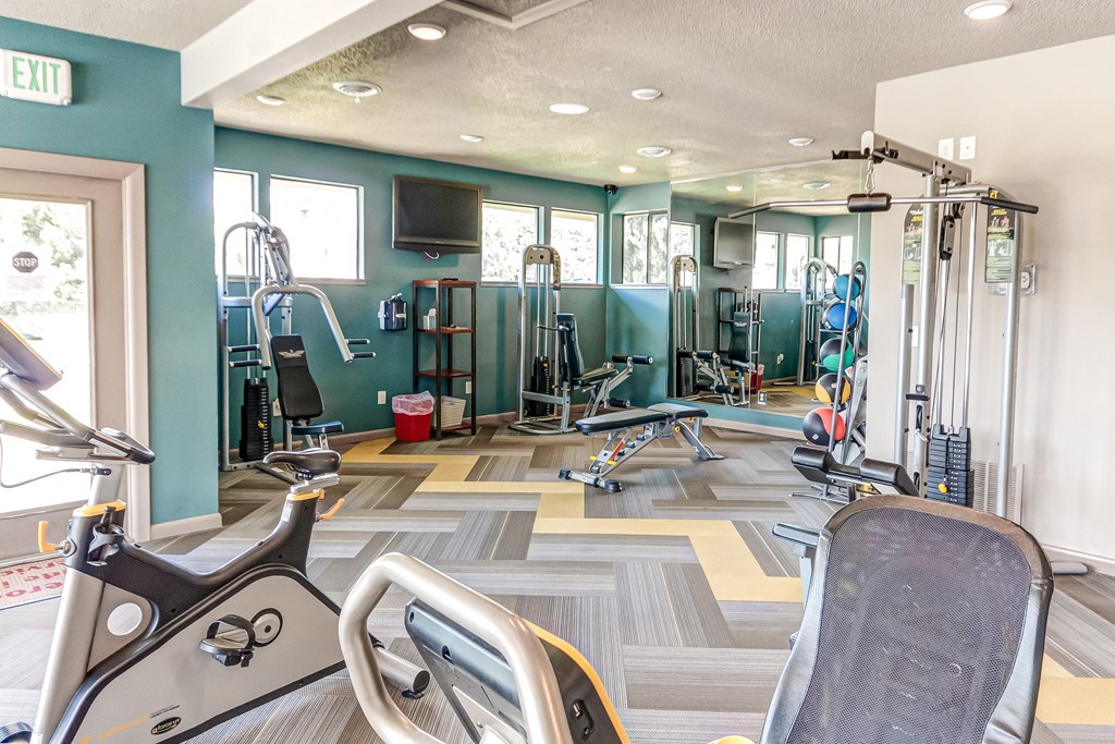 Gym with cardio machines and weights on the floor  at Union Heights Apartments, Colorado Springs, CO