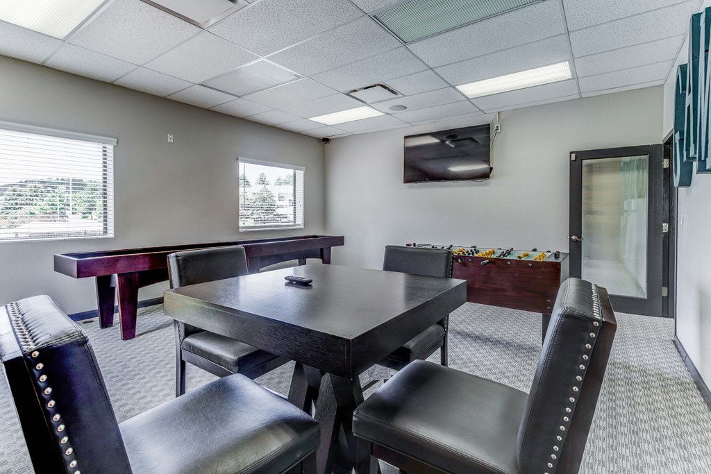 Gaming room with a table and chairs and a television  at Union Heights Apartments, Colorado Springs, CO