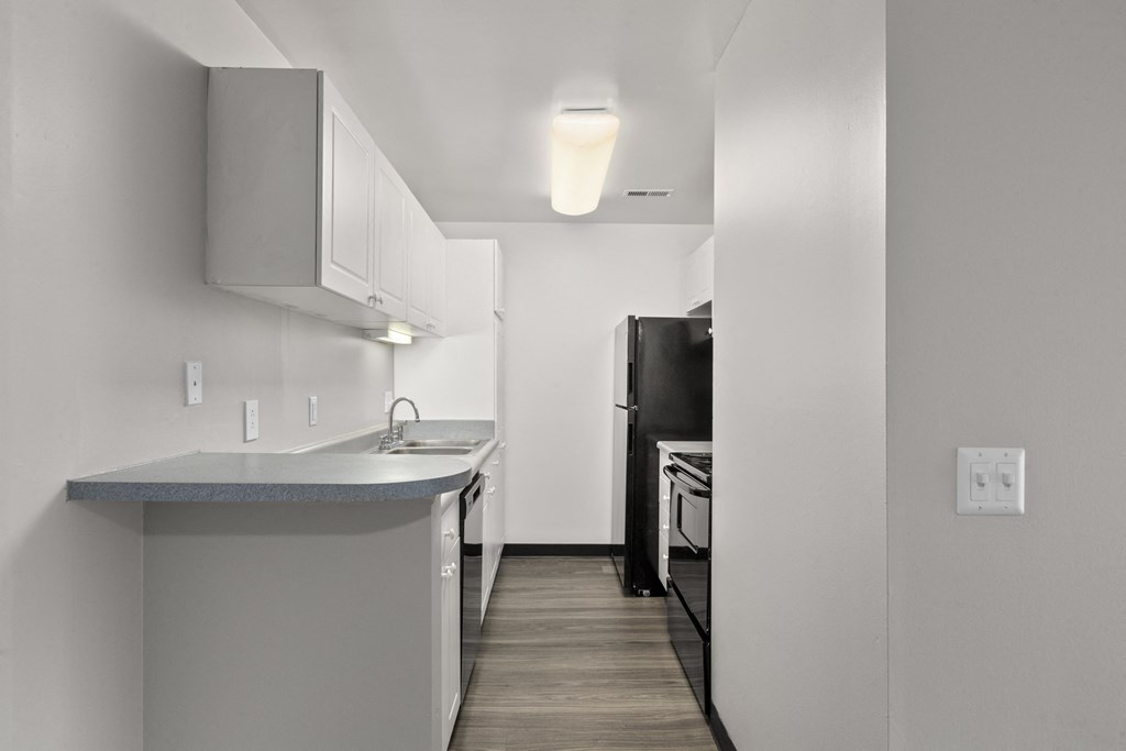 Kitchen with white cabinets and a black refrigerator at Creve Coeur, Creve Coeur, MO