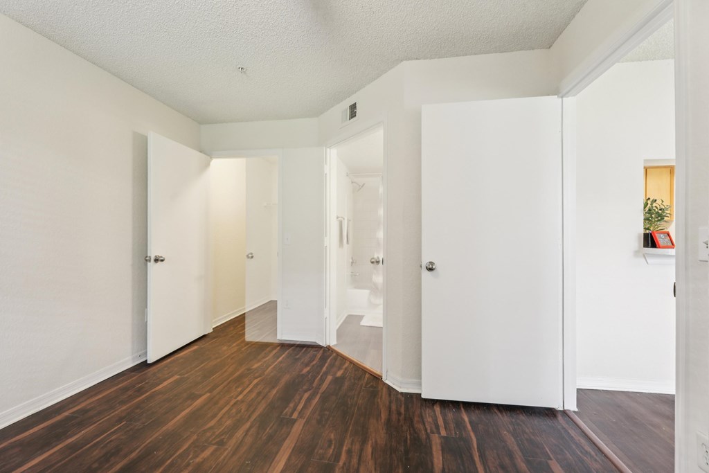 A hallway with white walls and wood floors. at University Park Apartments, Orlando, FL, 32817