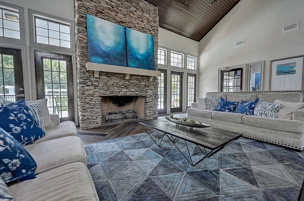 a living room with couches and a coffee table in front of a fireplace at St. Johns Forest Apartments, Florida, 32277
