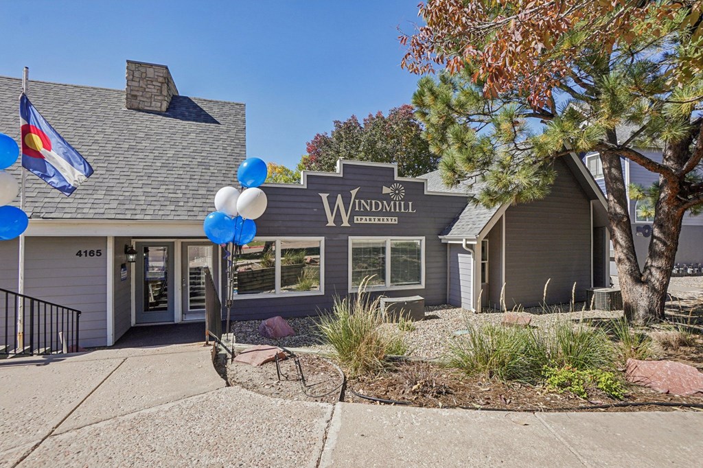 A house with a sign that says Windmill in front of it.