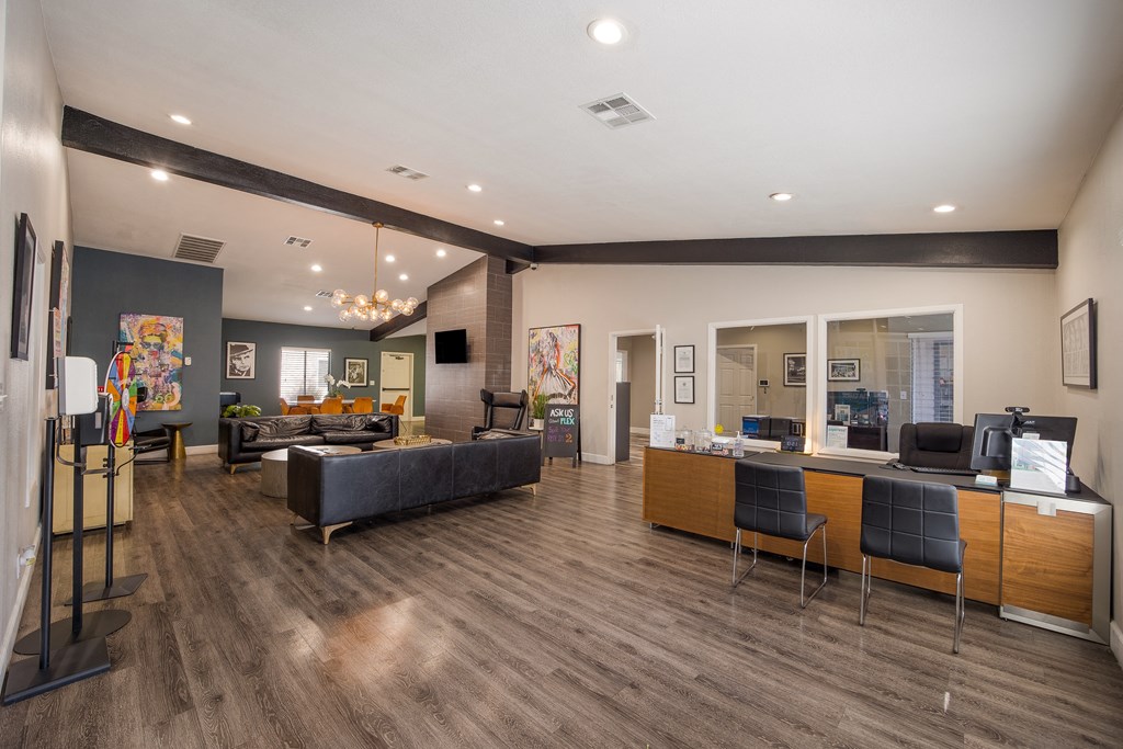 Community room with couches and chairs and a table with a computer at 2900 Lux Apartment Homes, Nevada