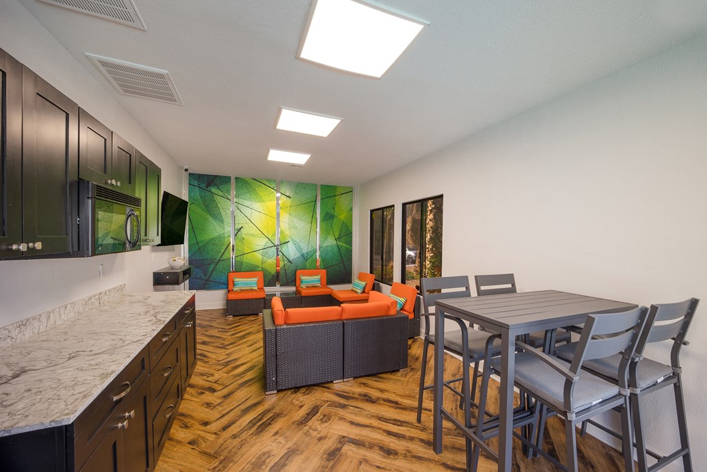 Clubhouse kitchen and dining room with a table and chairs at 2900 Lux Apartment Homes, Nevada