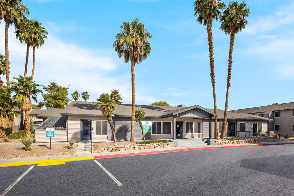 Clubhouse building with palm trees in front of it at 2900 Lux Apartment Homes, Nevada