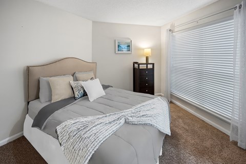 Bedroom with a bed and a large window at University Ridge Apartments, Durham, NC, 27707