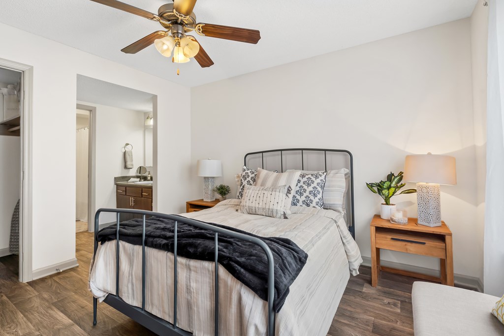 Bedroom with a bed Bedroom with a bed and a ceiling fan at Lofts of Wilmington, Wilmington, NC