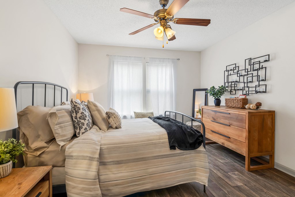 Bedroom with a bed and a ceiling fan at Lofts of Wilmington, Wilmington, NC