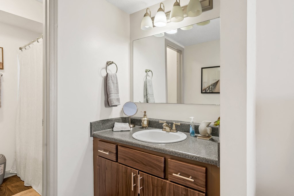 Bathroom with a sink and a mirror and a shower at Lofts of Wilmington, Wilmington, North Carolina