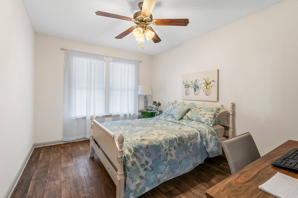 Bedroom with a bed and a ceiling fan and a desk at Lofts of Wilmington, Wilmington