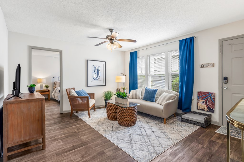 Living room with a couch and a ceiling fan at Lofts of Wilmington, Wilmington, NC