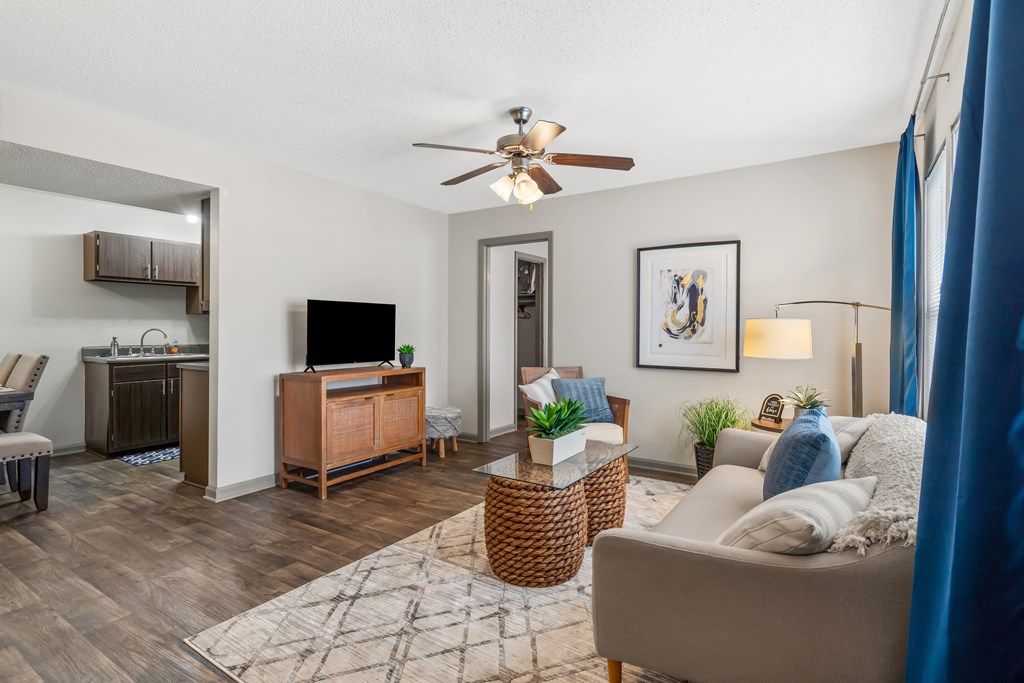 Living room with a couch and a chair and a ceiling fan at Lofts of Wilmington, Wilmington, NC