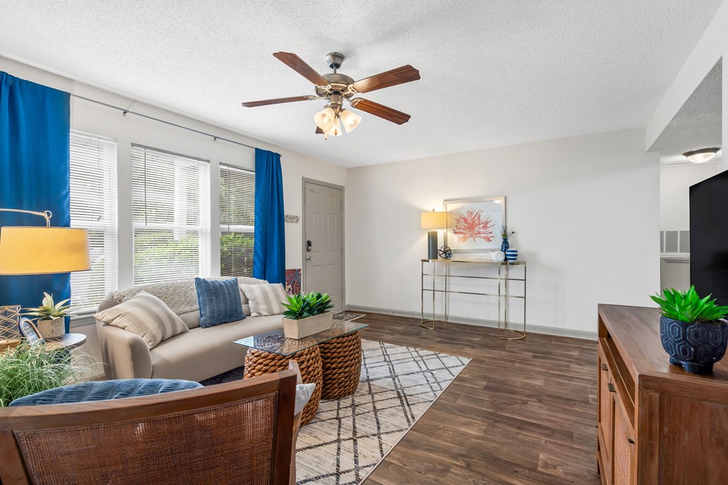 Living room with a couch and a ceiling fan at Lofts of Wilmington, Wilmington, NC