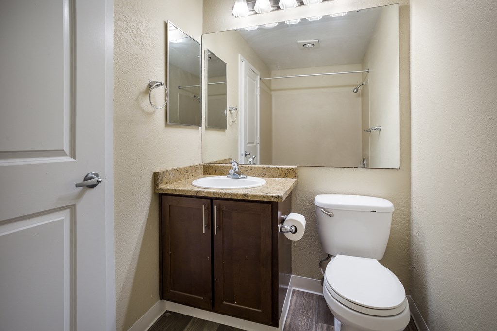 A bathroom with a sink toilet and mirror at Arcadia Townhomes, Federal Way, WA