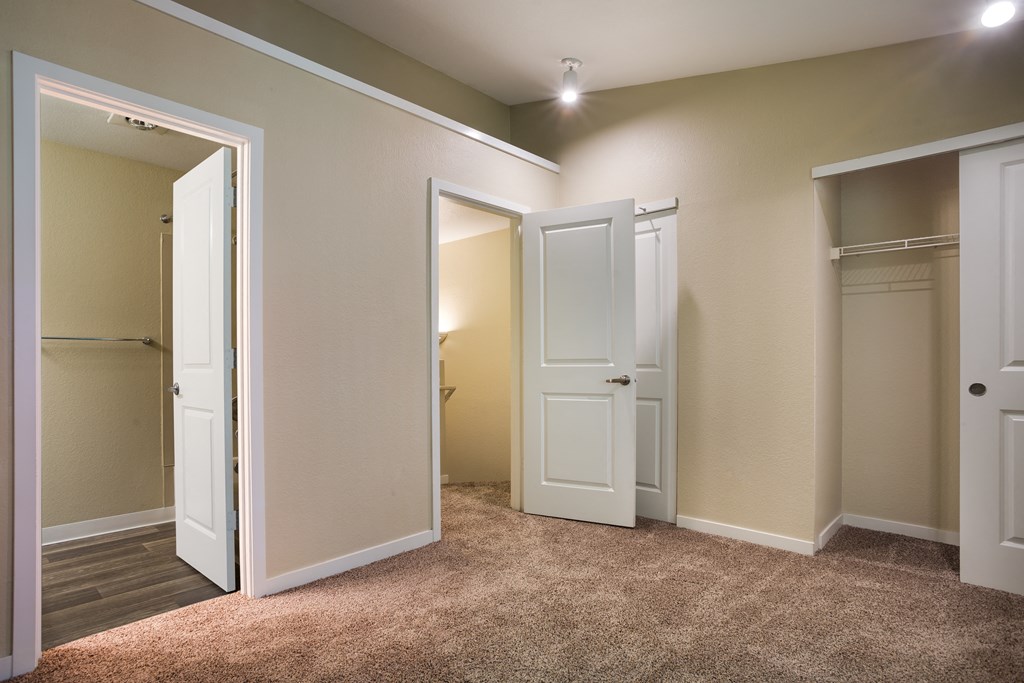 A bedroom with two doors at Arcadia Townhomes, Federal Way, WA