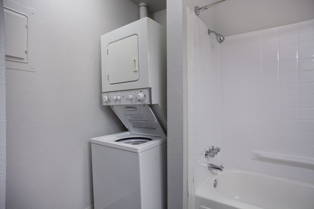 White washer and dryer in a bathroom with a shower and a sink  at Governor's Park, Fort Collins, 80525