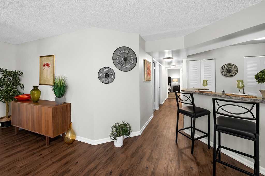 a living room with a bar and a kitchen with a dining room table and chairs at Pembroke Pines Landings, Pembroke Pines