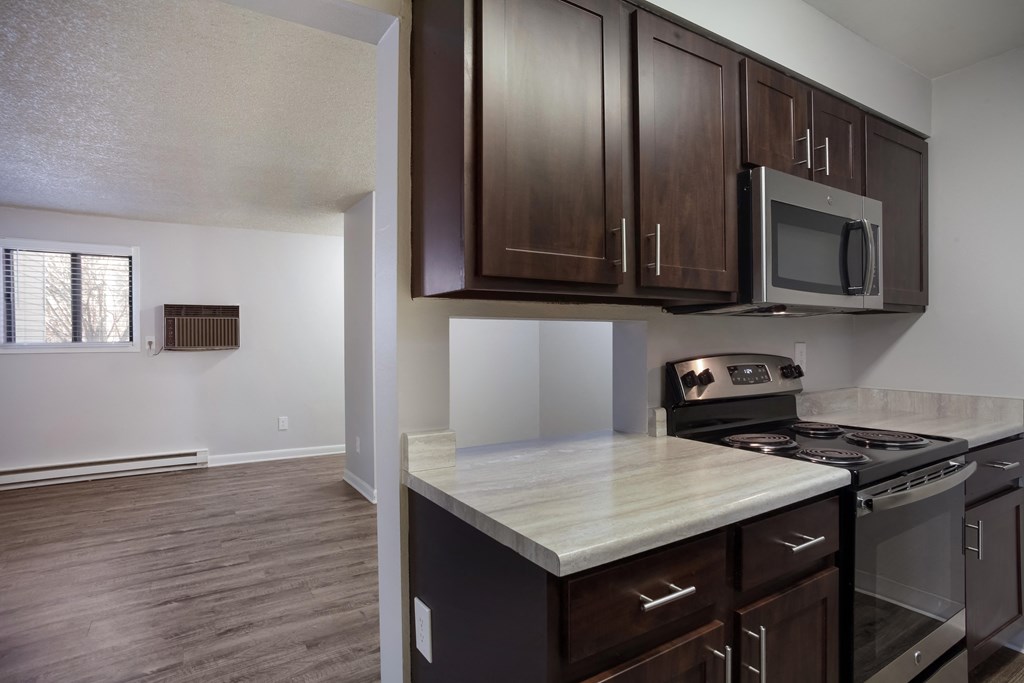 Empty kitchen with wooden cabinets and a stove   at Governor's Park, Fort Collins, 80525