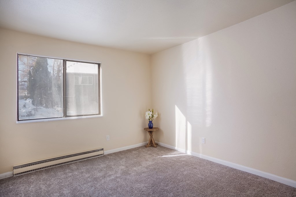 Empty living room with a large window and carpet  at Governor's Park, Fort Collins, 80525