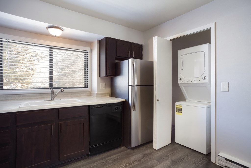 Empty kitchen with a washer and dryer in closet  at Governor's Park, Fort Collins, 80525