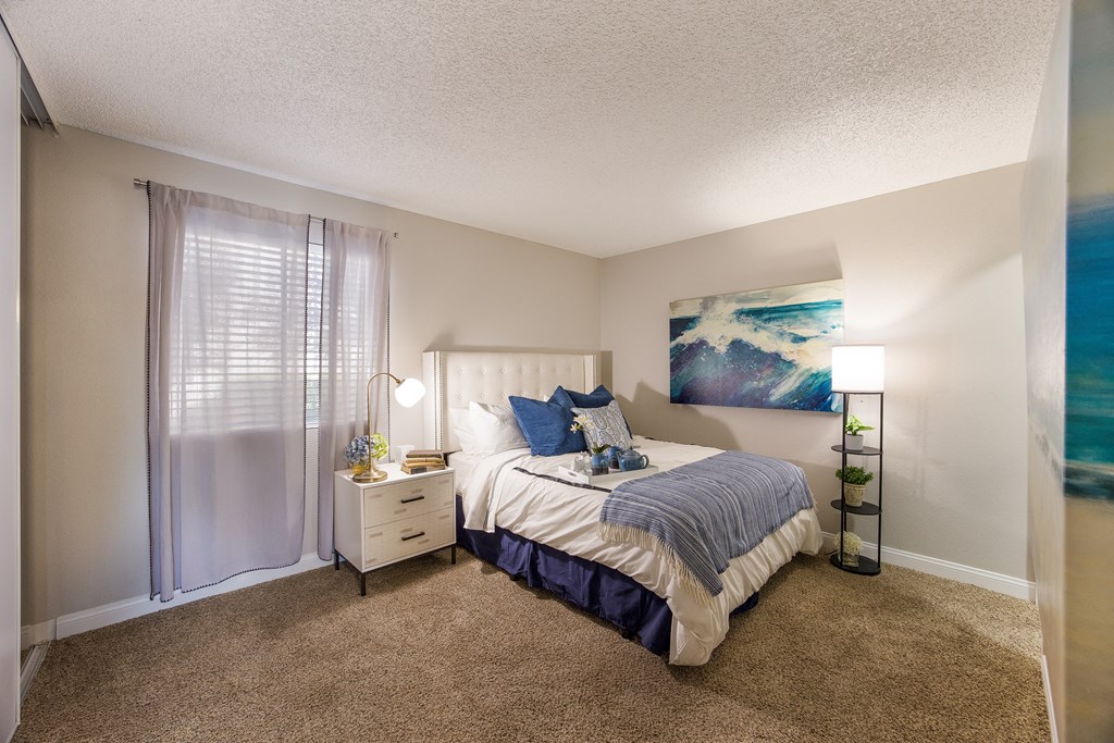 Bedroom with a bed and a window at 2900 Lux Apartment Homes, Nevada