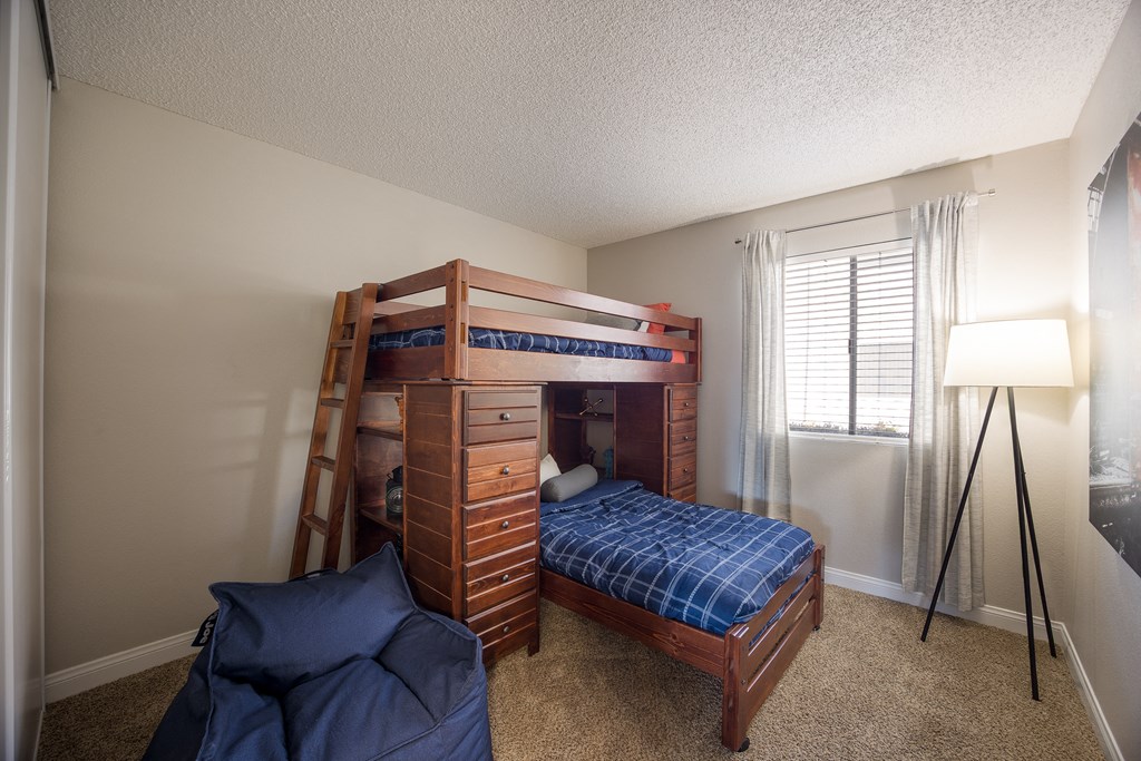 Bedroom with a bunk bed and a window at 2900 Lux Apartment Homes, Nevada