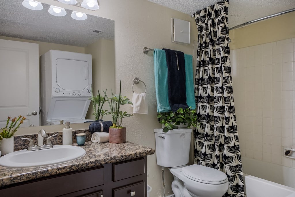 Bathroom with a tub, sink and toilet at Mountain Run Apartments, New Mexico, 87111