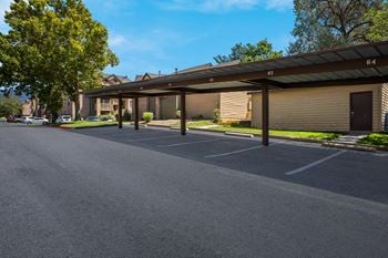 a parking lot with a building in the background at Mountain Run Apartments, New Mexico, 87111