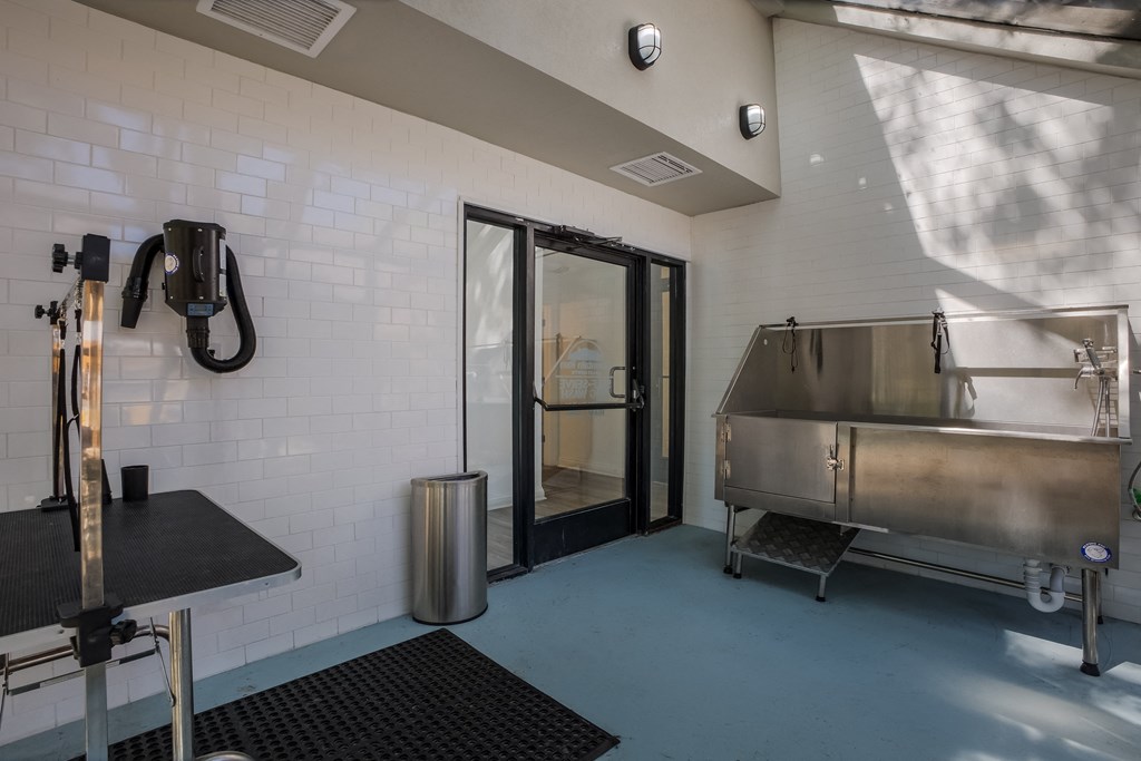 Dog washing station with large steel tub  with a grooming station at Mountain Run Apartments, New Mexico, 87111