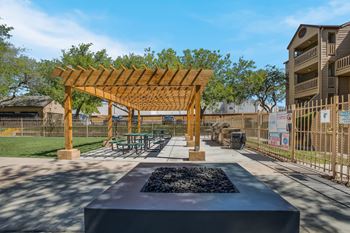 Outdoor patio with a firepit and pergola at Mountain Run Apartments, New Mexico, 87111