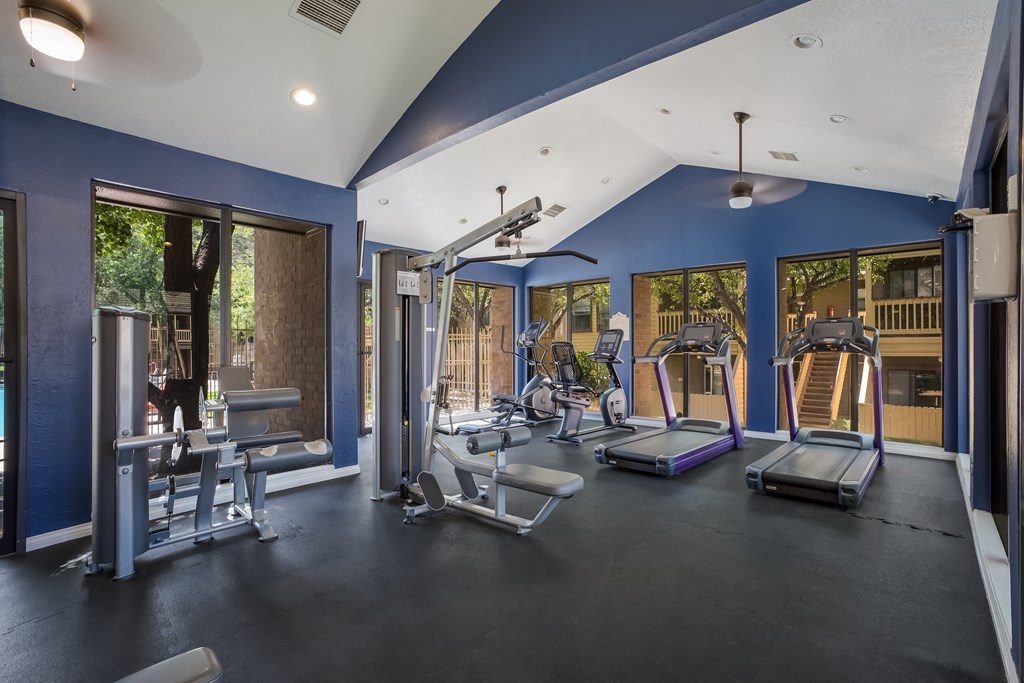 Gym with exercise equipment and windows at Mountain Run Apartments, Albuquerque, NM