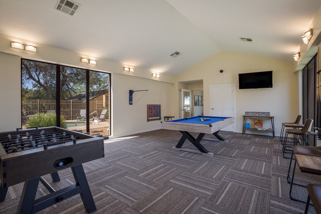 Game room with a pool table foosball and ping pong at Mountain Run Apartments, Albuquerque