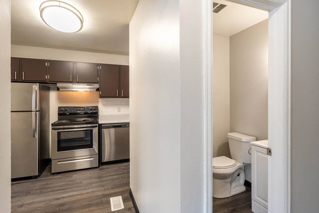 a kitchen and bathroom with stainless steel appliances at Aspen Townhomes, Colorado Springs, CO