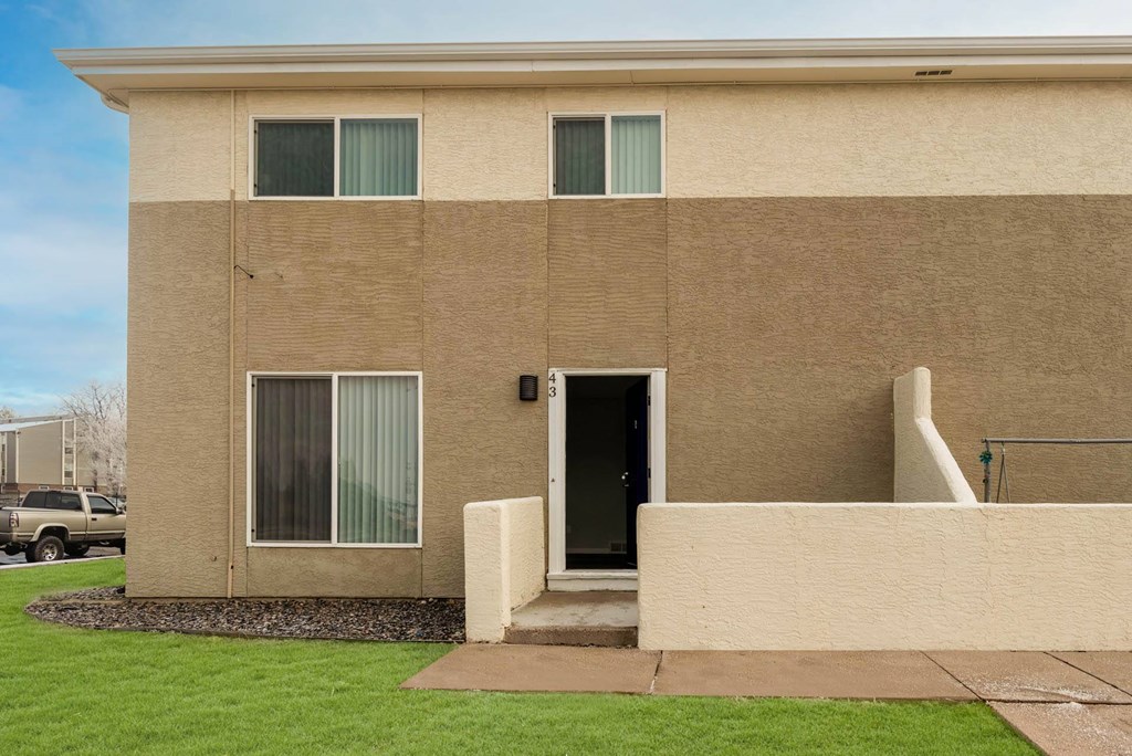 a building with a grassy yard in front of it