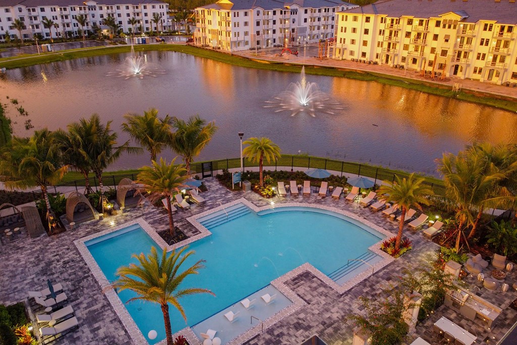 Sunset Drone View of Buildings, Pool, and Lake at Edge75, Naples, FL 34104