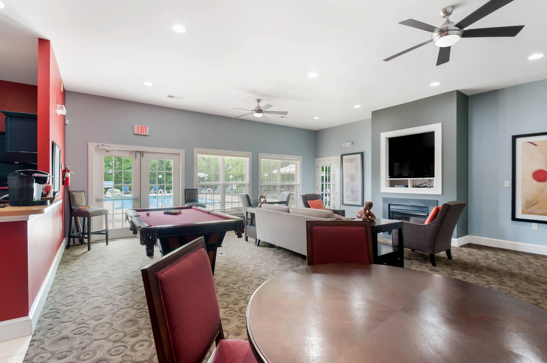 a clubhouse with a pool table and a living room