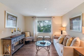 Living Room With Expansive Window at Sarasota South, Bradenton, Florida