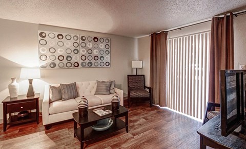 Living Room with Wood Style Flooring at University Village Apartments, Colorado Springs, CO, 80918