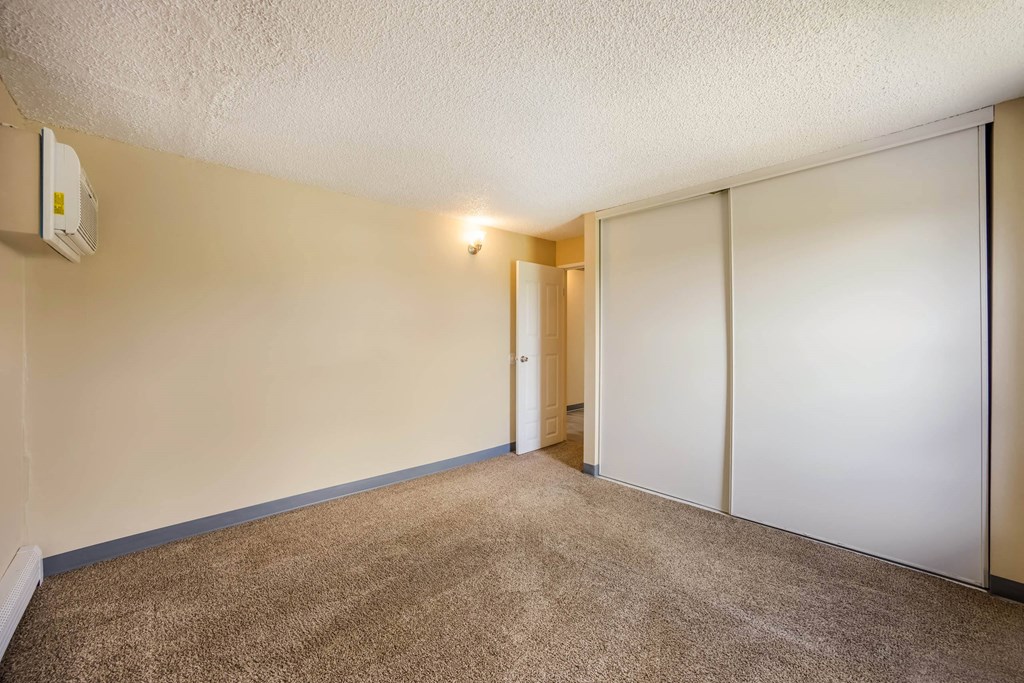 a bedroom with white walls and a carpeted floor at Broadmoor Springs, Colorado Springs, CO, 80906