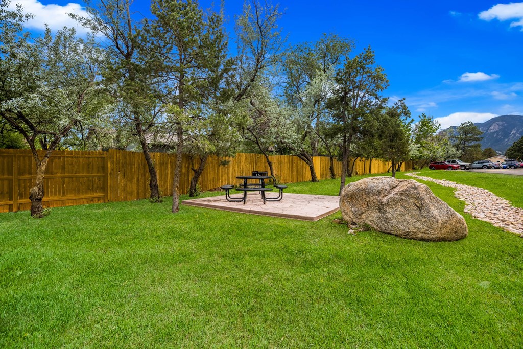 a picnic table in the backyard of a home with a wooden fence at Broadmoor Springs, Colorado Springs, CO, 80906