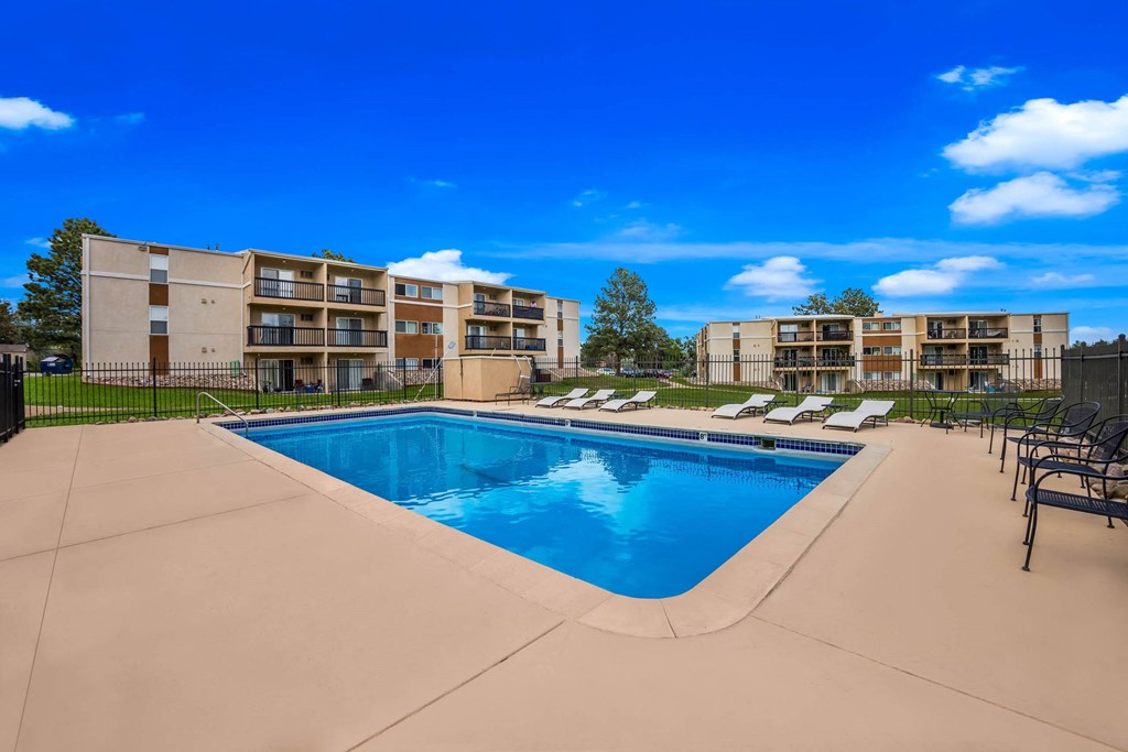 pool with lounge chairs at the bradley braddock road station apartments