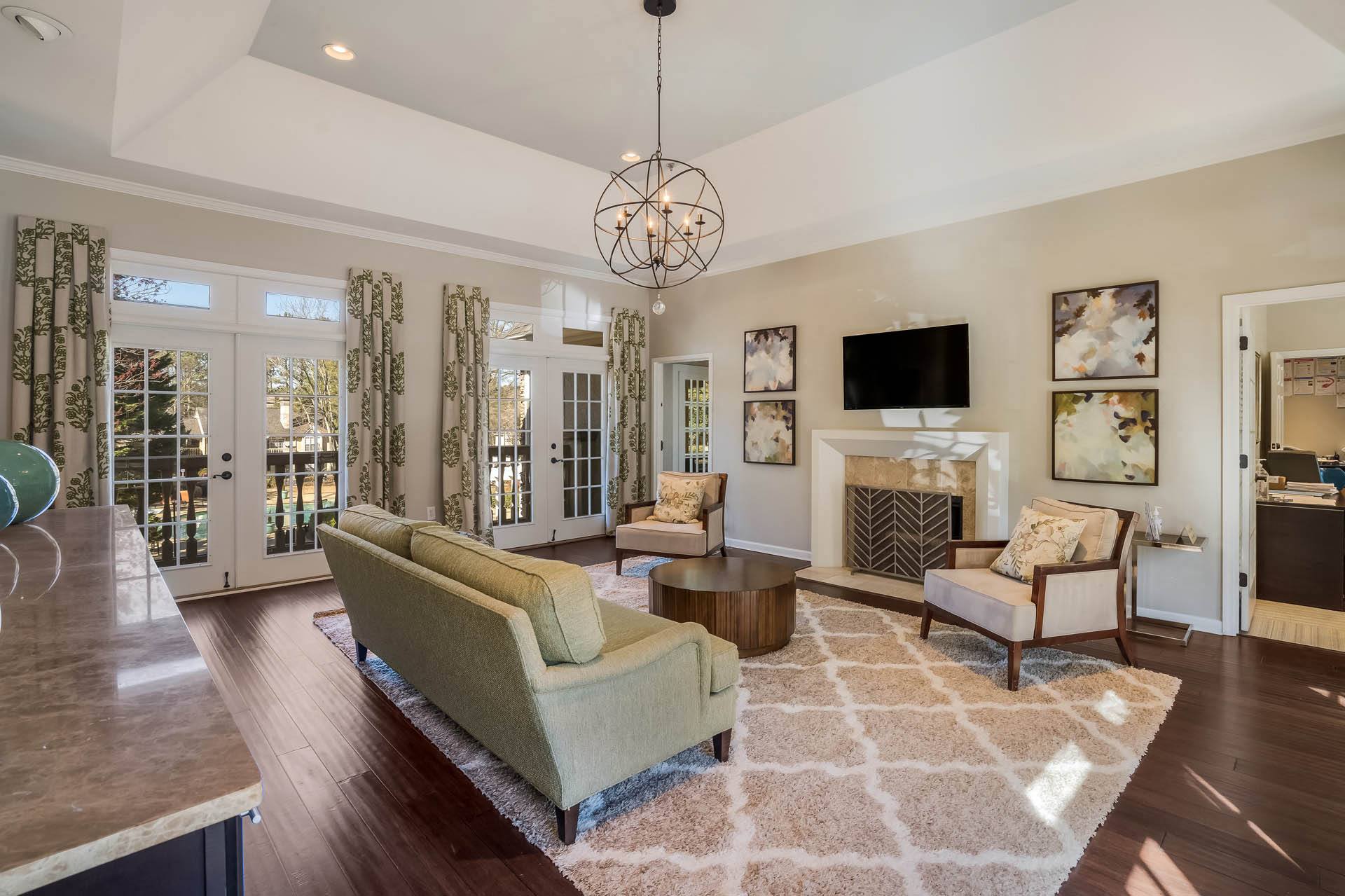 a living room with a couch and chairs and a fireplace