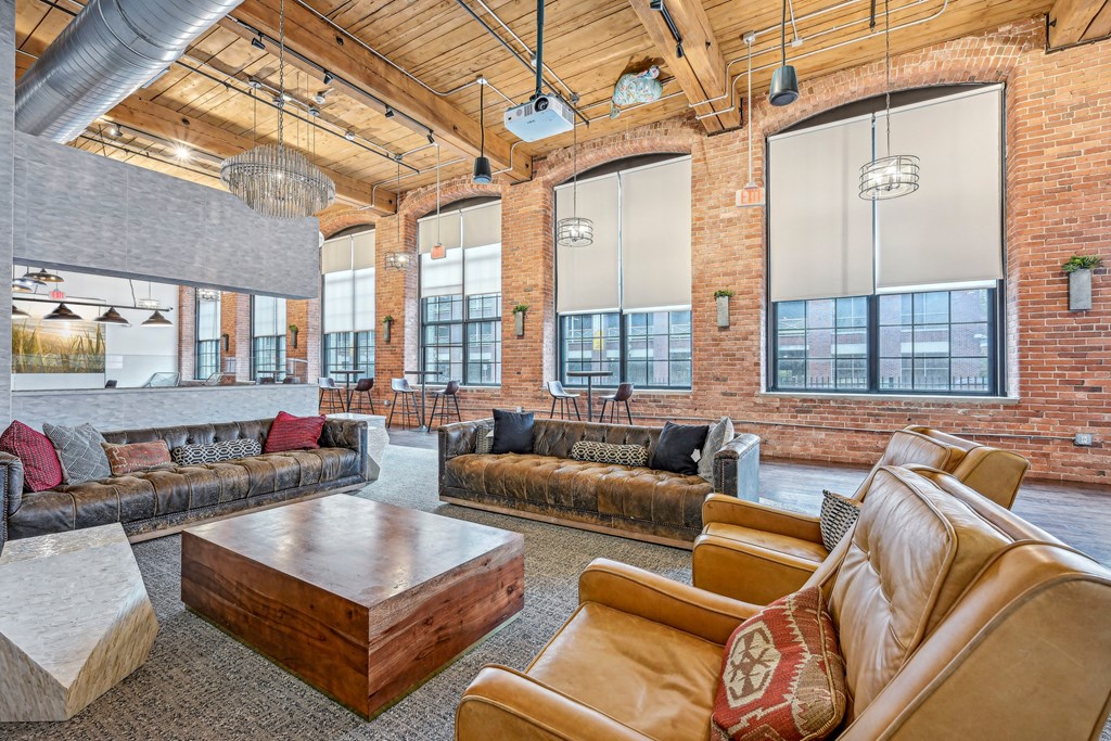 a large living room with couches and a coffee table at Riverwalk Apartments, Lawrence, MA