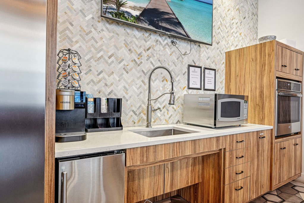a kitchen with a sink and a microwave at Riverwalk Apartments, Lawrence, MA