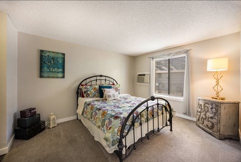 Bedroom with a bed and a window at Windmill Apartments, Colorado, 80916