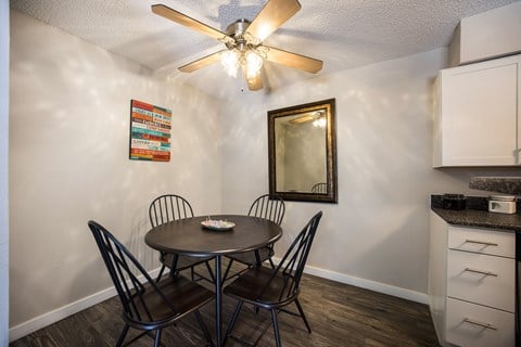 Dining area with a table and four chairs at Windmill Apartments, Colorado, 80916