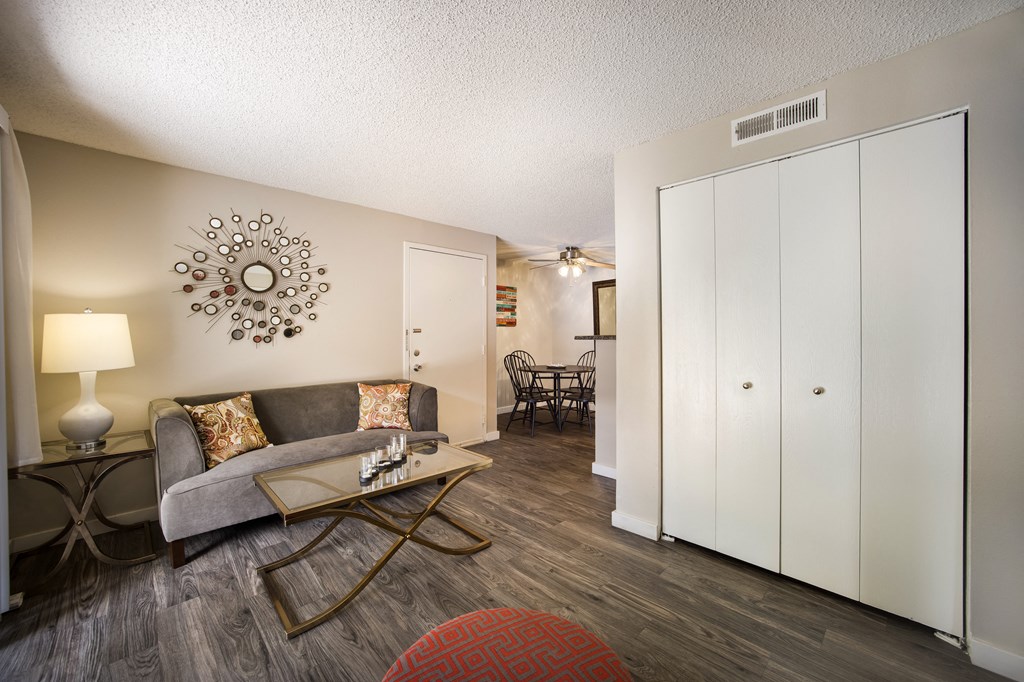 Living room with a couch and coffee table at Windmill Apartments, Colorado, 80916