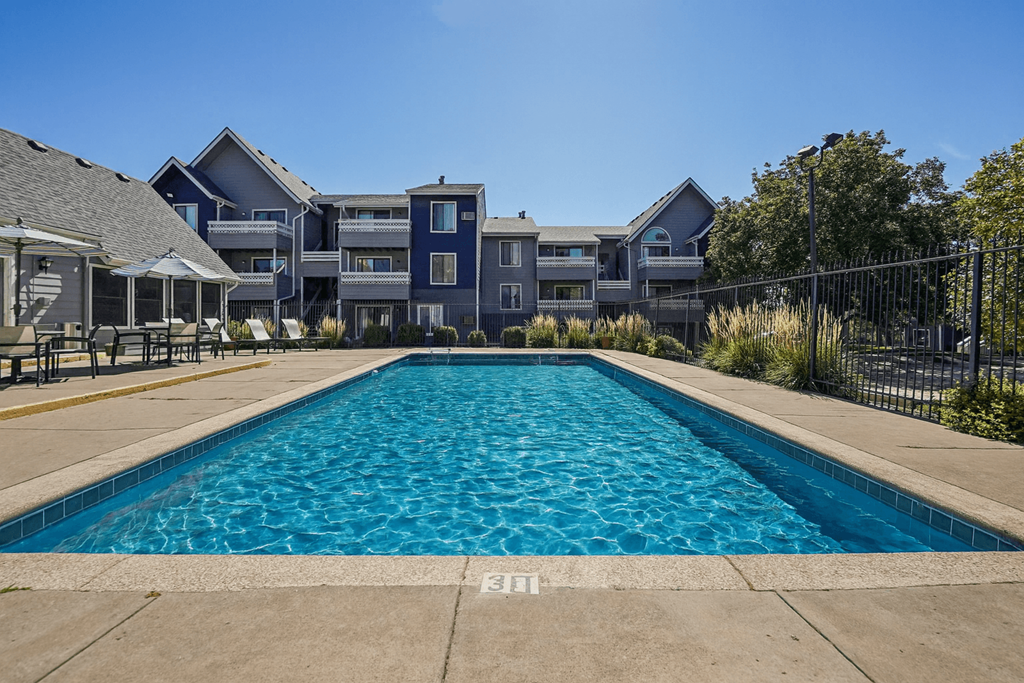 A large swimming pool in front of a building.